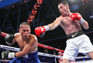 Egor Mekhontsev (R) stops Mike Merafuentes in the 3rd round at The Venetian Macao Resort in Macau, China.